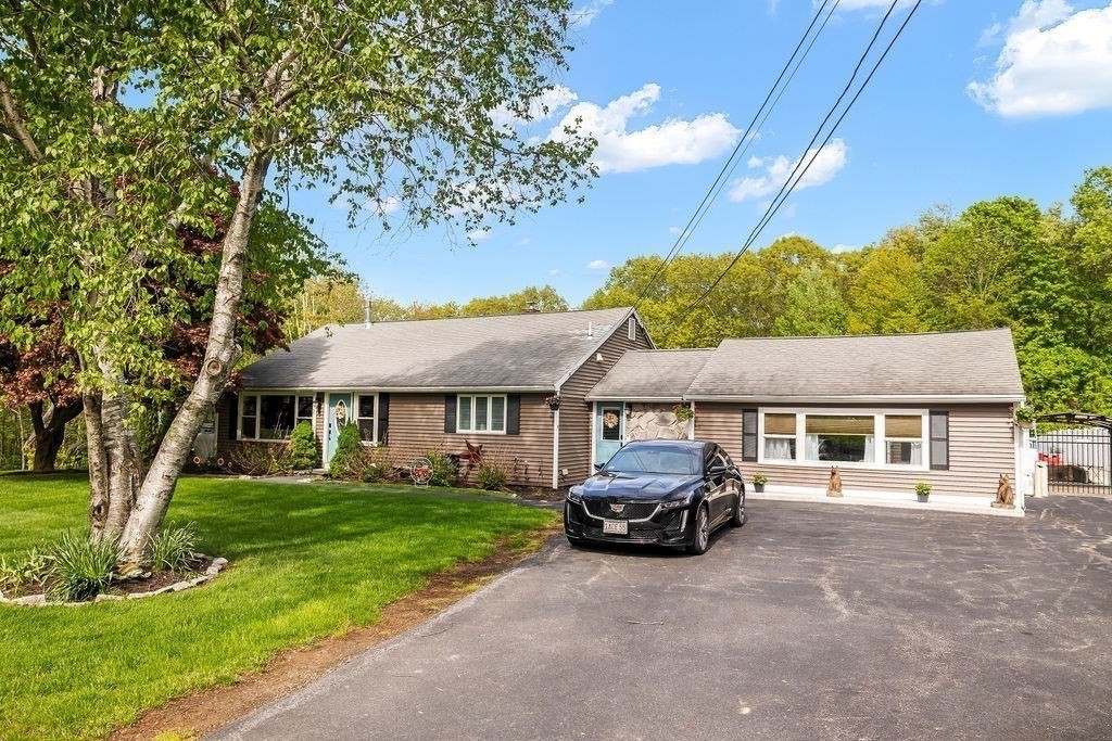8 New Spencer Road Charlton, MA 01507 - Photo 41 of 42 a car parked in front of white house