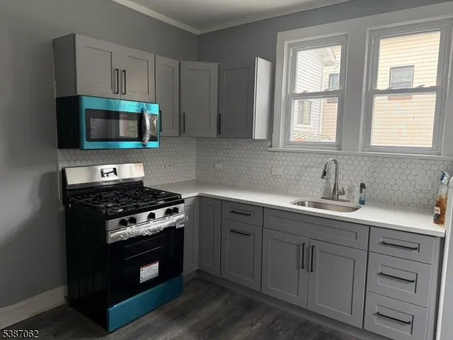 a kitchen with stainless steel appliances a stove sink and cabinets