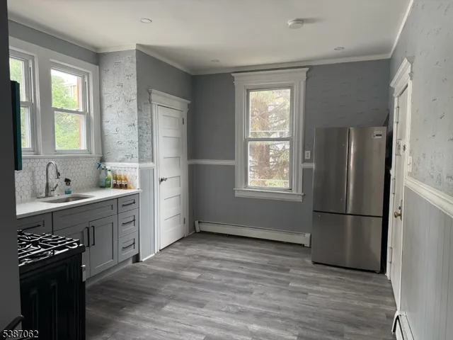 a kitchen with a refrigerator and a stove top oven