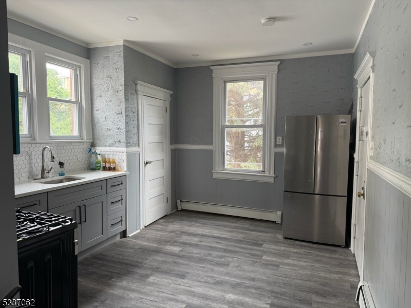 31 Tappan Street, Unit 1 Kearny, NJ 07032 - Photo 4 of 9 a kitchen with a refrigerator and a stove top oven
