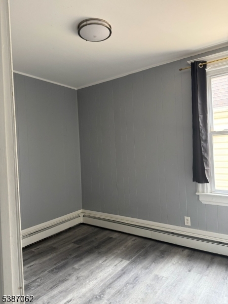 31 Tappan Street, Unit 1 Kearny, NJ 07032 - Photo 6 of 9 an empty room with wooden floor and windows