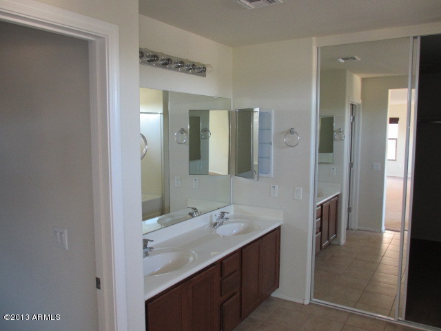 43500 West Magnolia Road Maricopa, AZ 85138 - Photo 23 of 35 a bathroom with a sink and a mirror