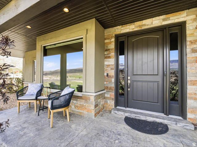 402 Shadow Hill Road Wanship, UT 84017 - Photo 6 of 90 View of exterior entry featuring stone siding and a mountain view