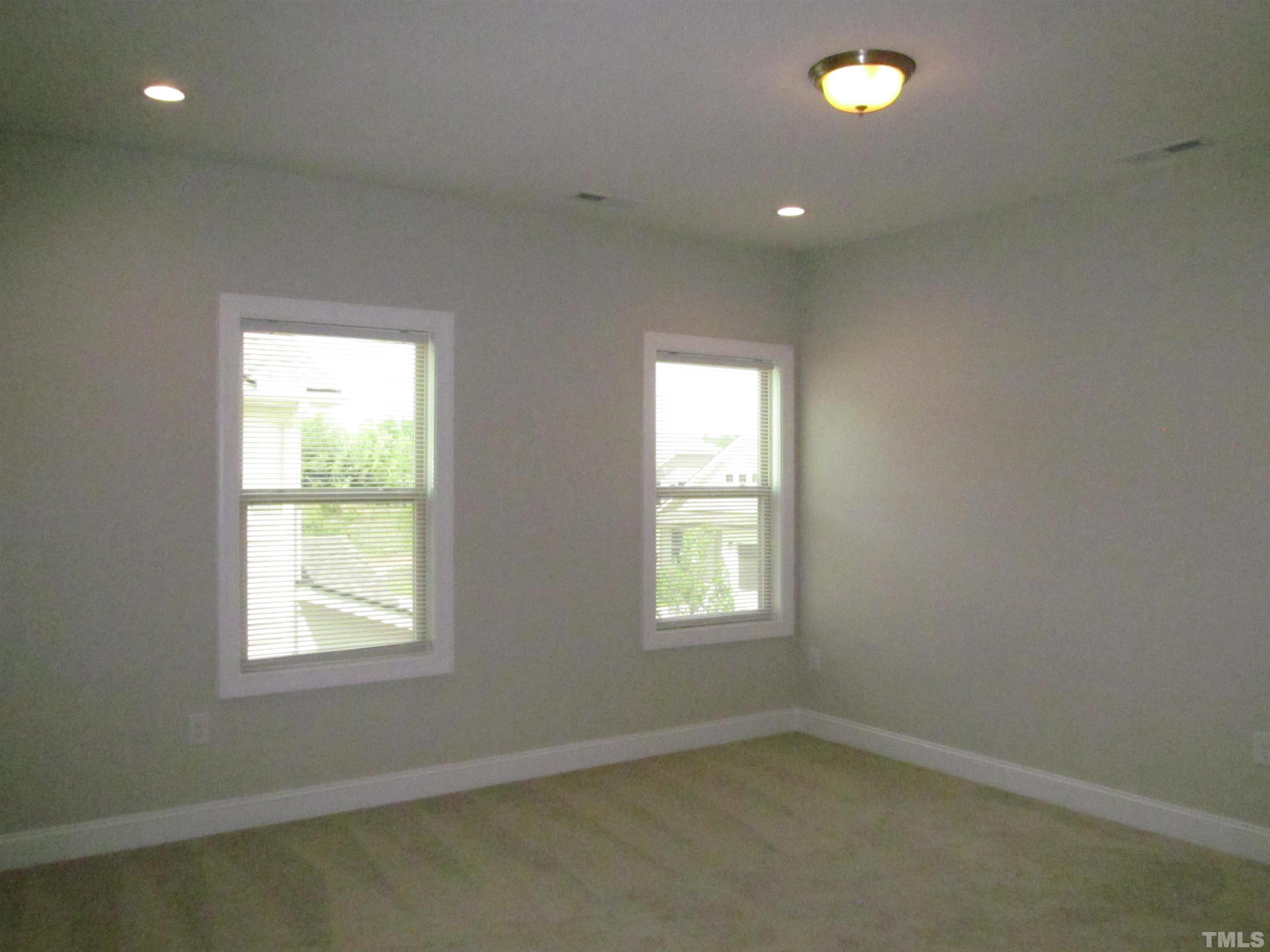 1248 Magic Hollow Road Durham, NC 27713 - Photo 11 of 13 an empty room with a empty space and window