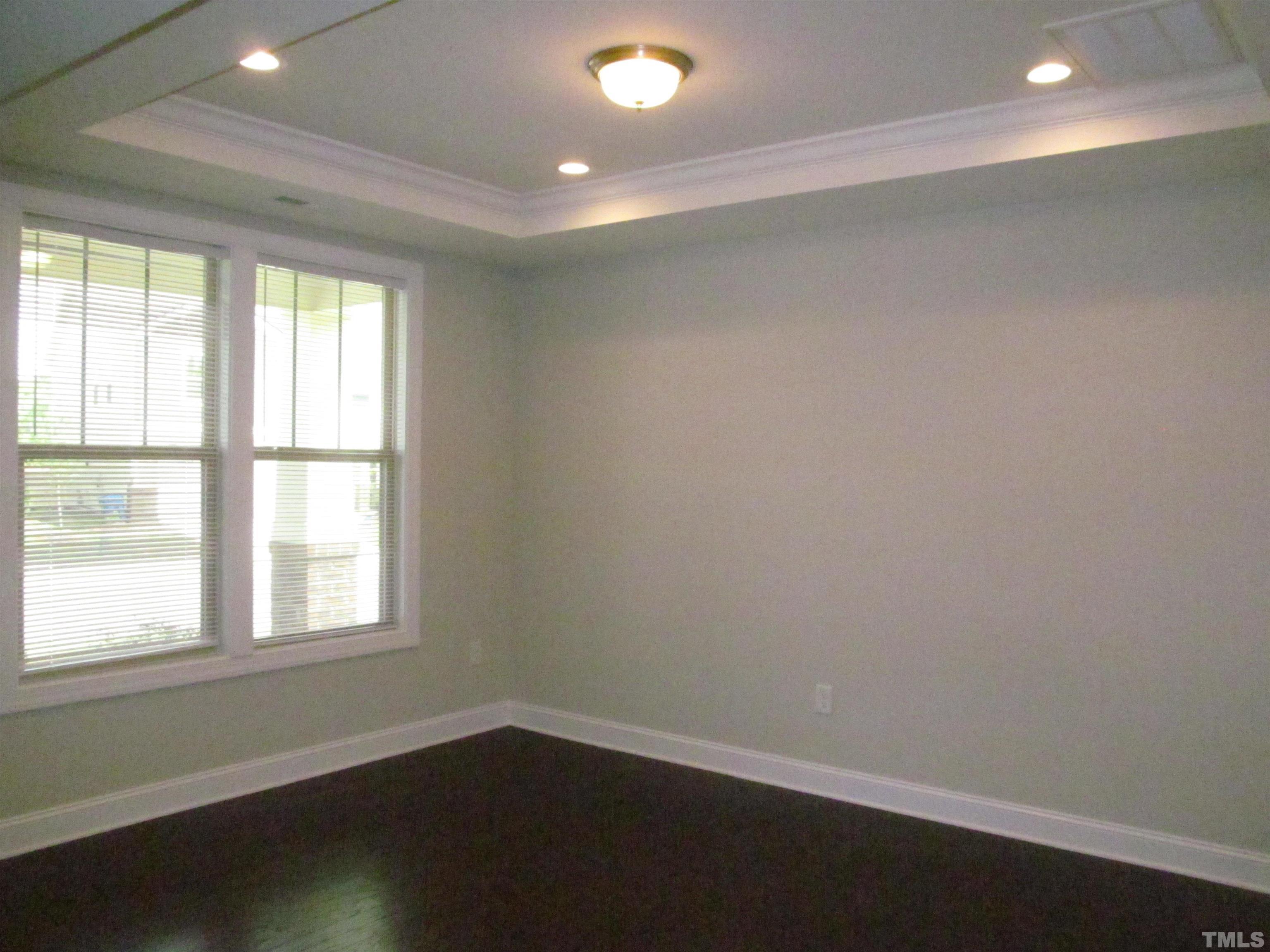 1248 Magic Hollow Road Durham, NC 27713 - Photo 2 of 13 an empty room with wooden floor and windows