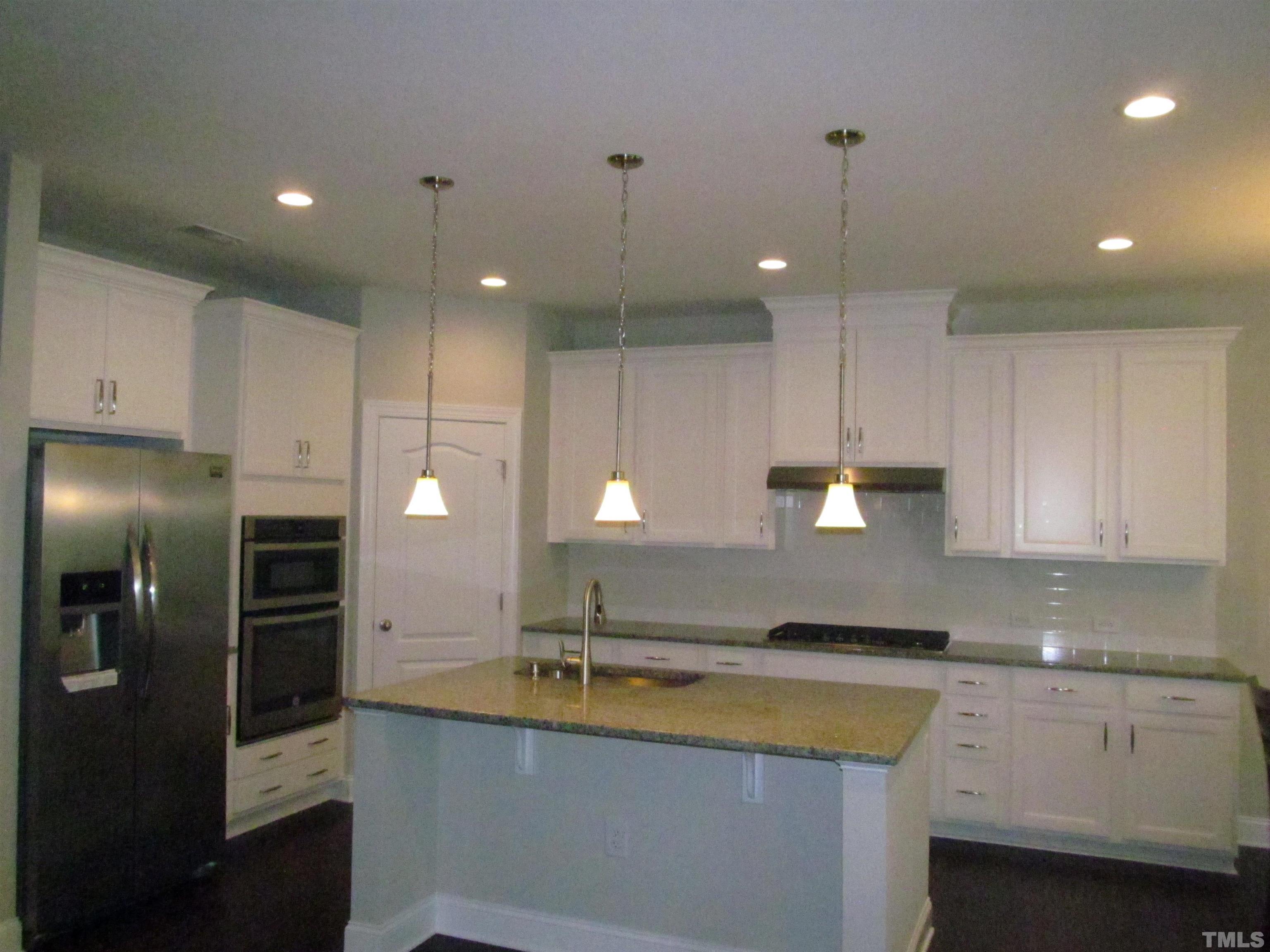 1248 Magic Hollow Road Durham, NC 27713 - Photo 3 of 13 a large kitchen with stainless steel appliances kitchen island a large counter top