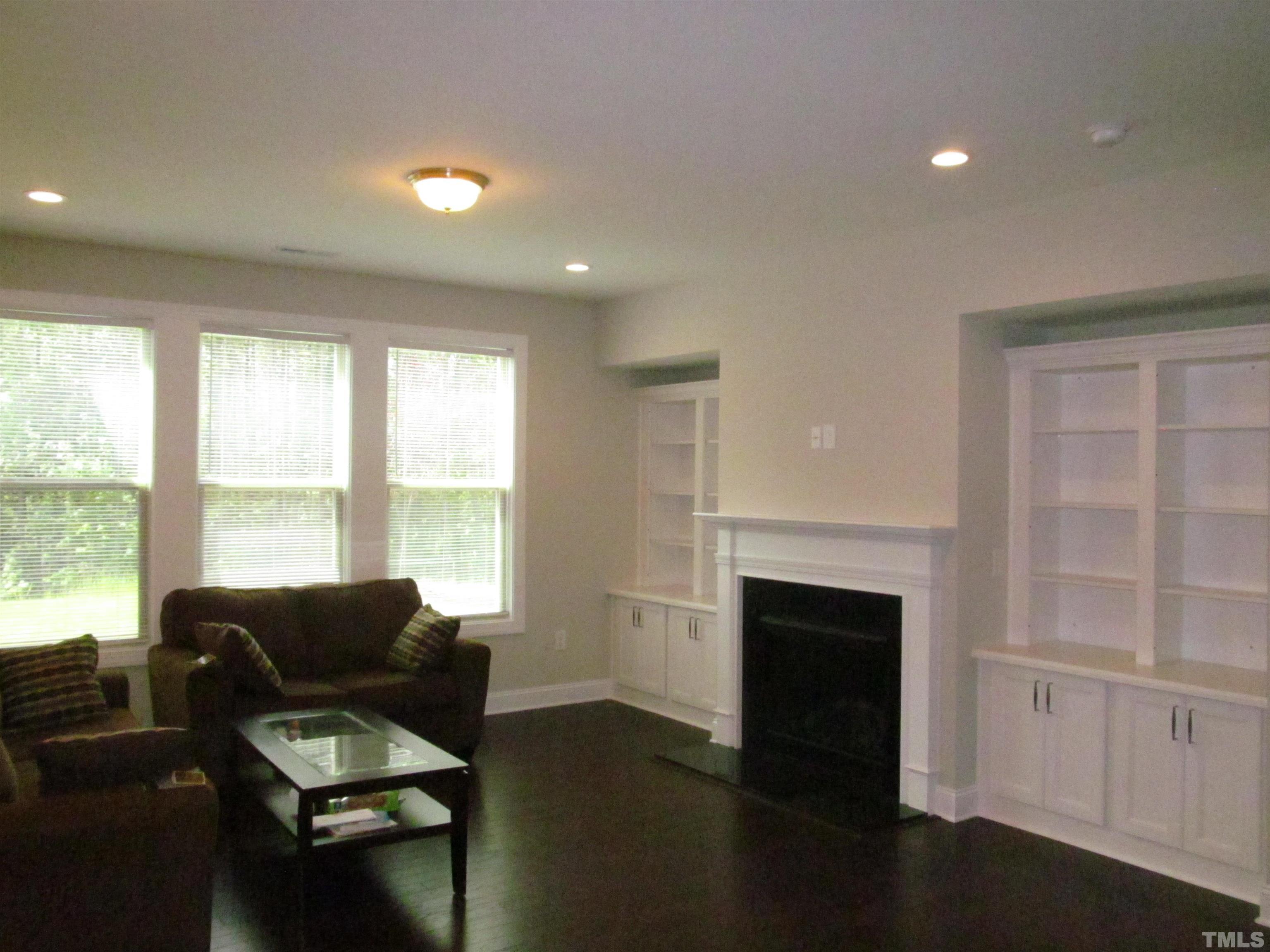 1248 Magic Hollow Road Durham, NC 27713 - Photo 5 of 13 a living room with furniture and a fireplace