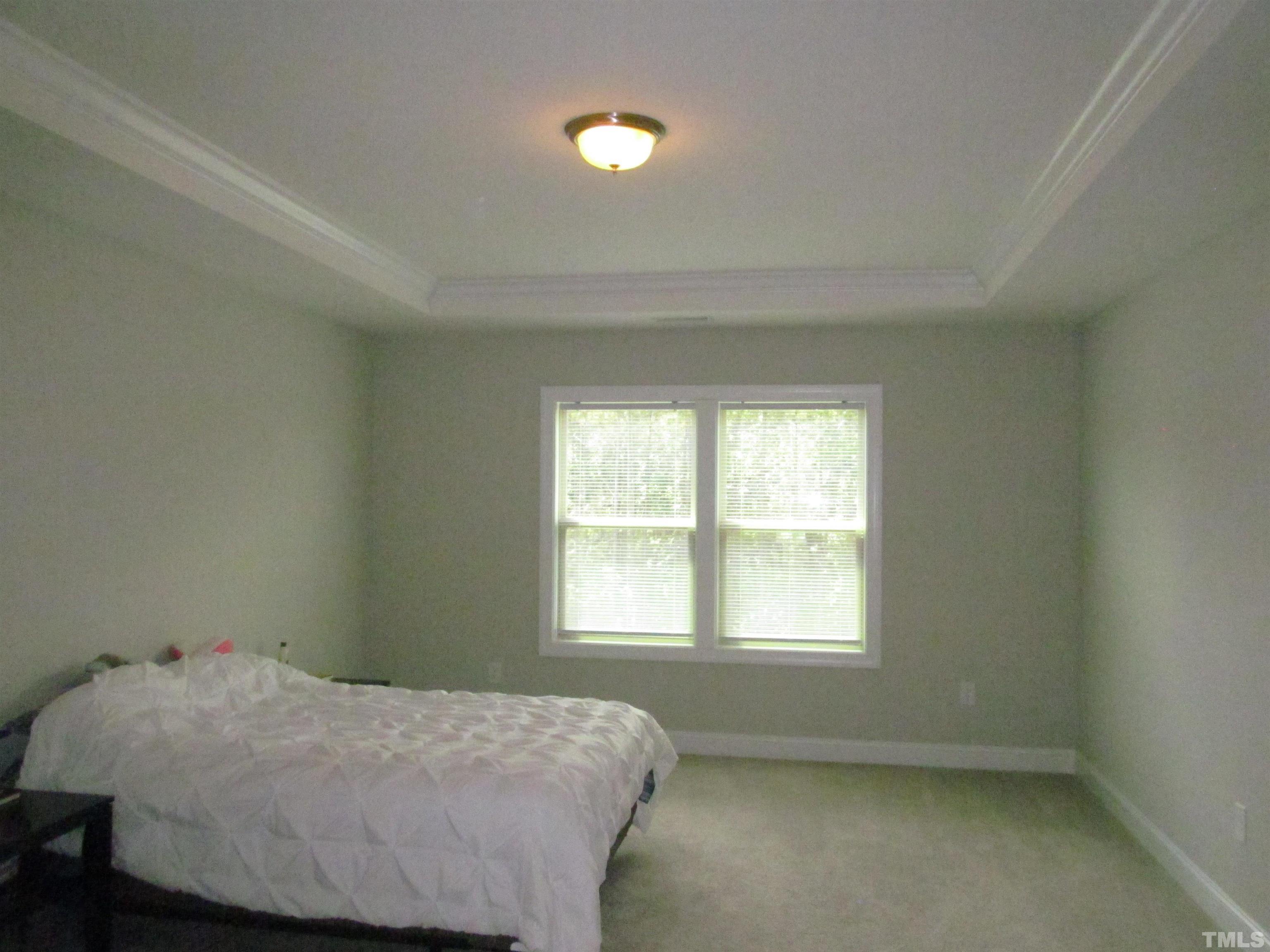 1248 Magic Hollow Road Durham, NC 27713 - Photo 6 of 13 a bedroom with a bed and a window
