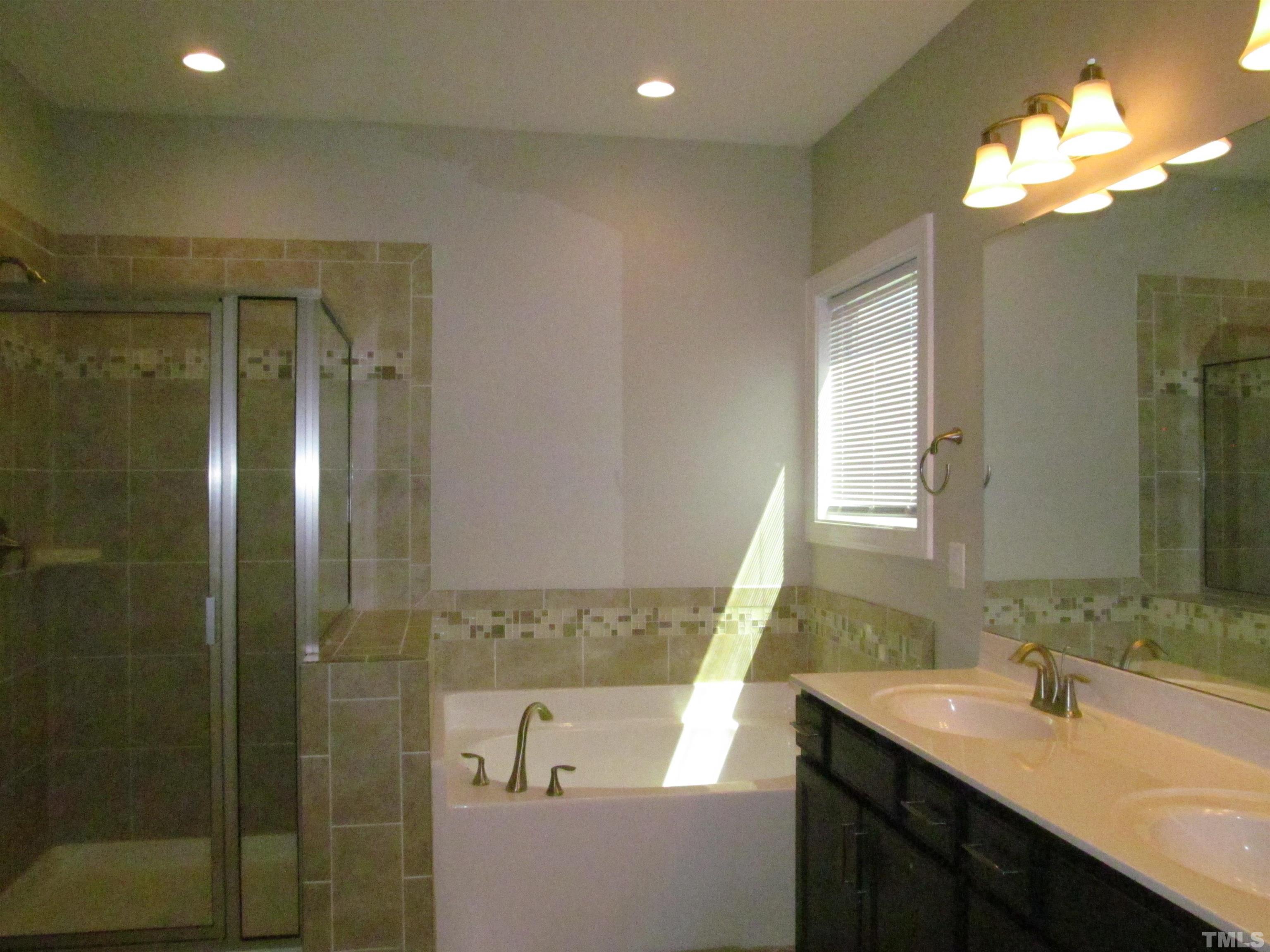 1248 Magic Hollow Road Durham, NC 27713 - Photo 7 of 13 a bathroom with a double vanity sink mirror and shower