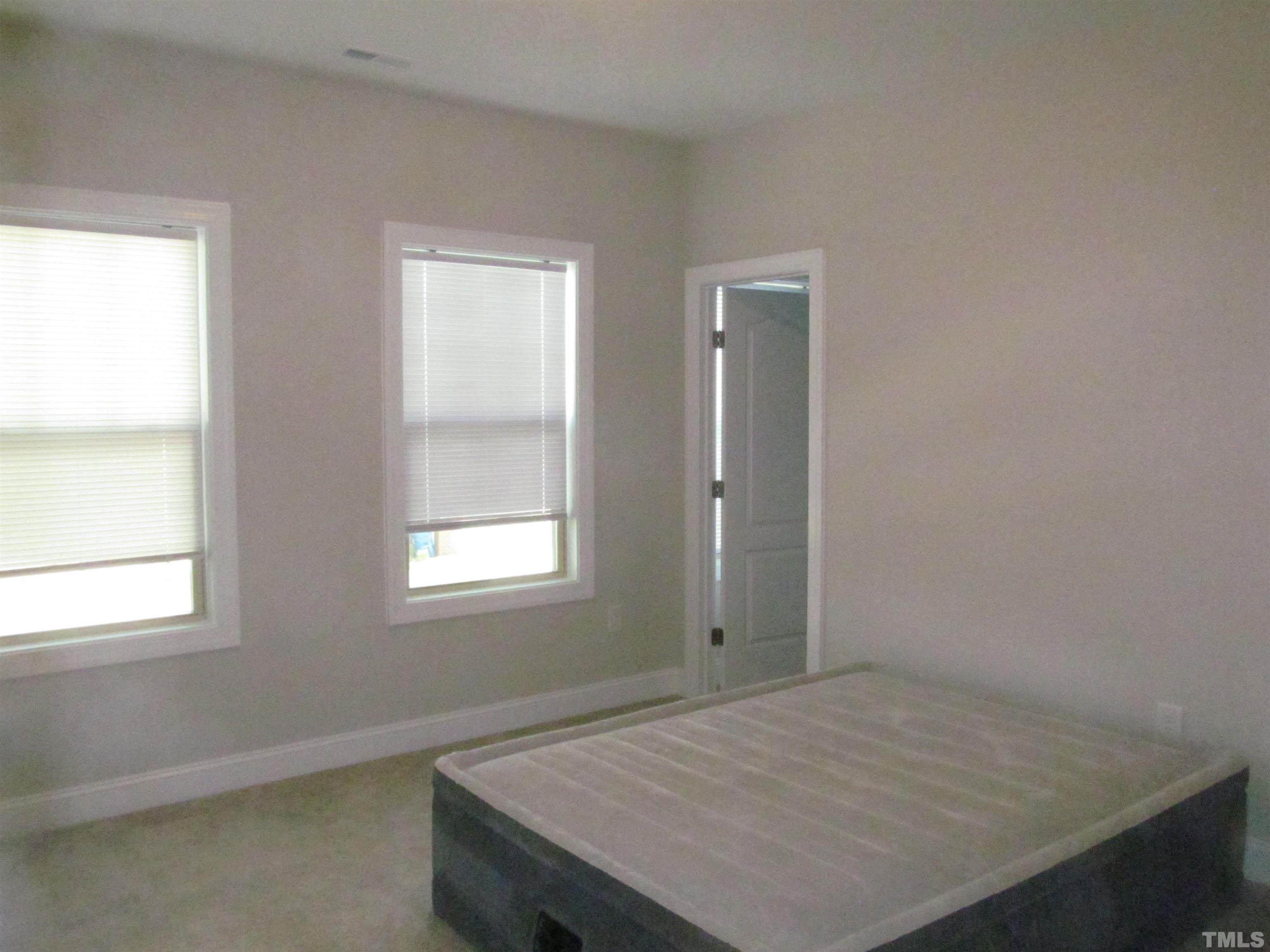 1248 Magic Hollow Road Durham, NC 27713 - Photo 9 of 13 a room that has a bed and a window