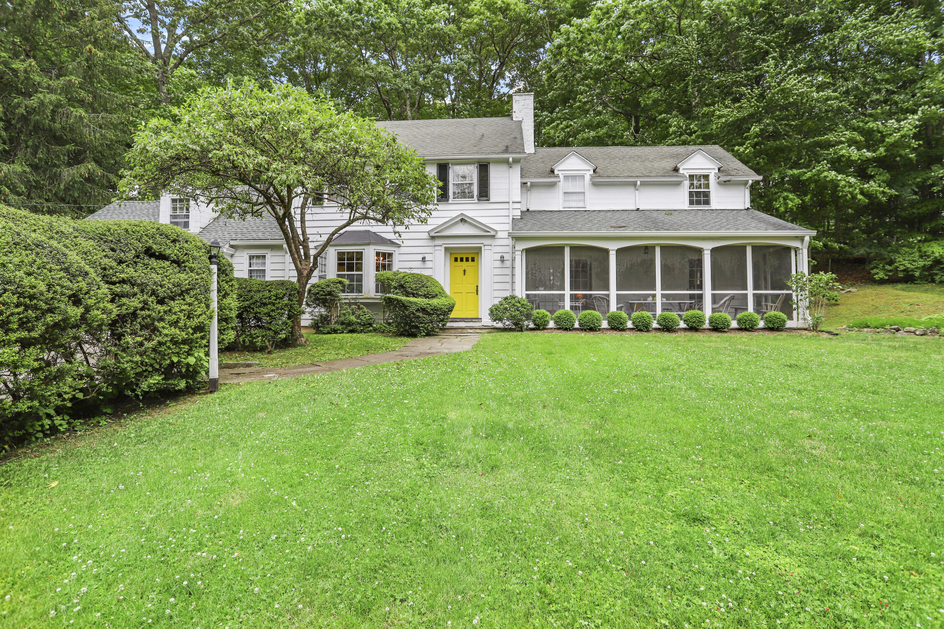 a front view of a house with a garden