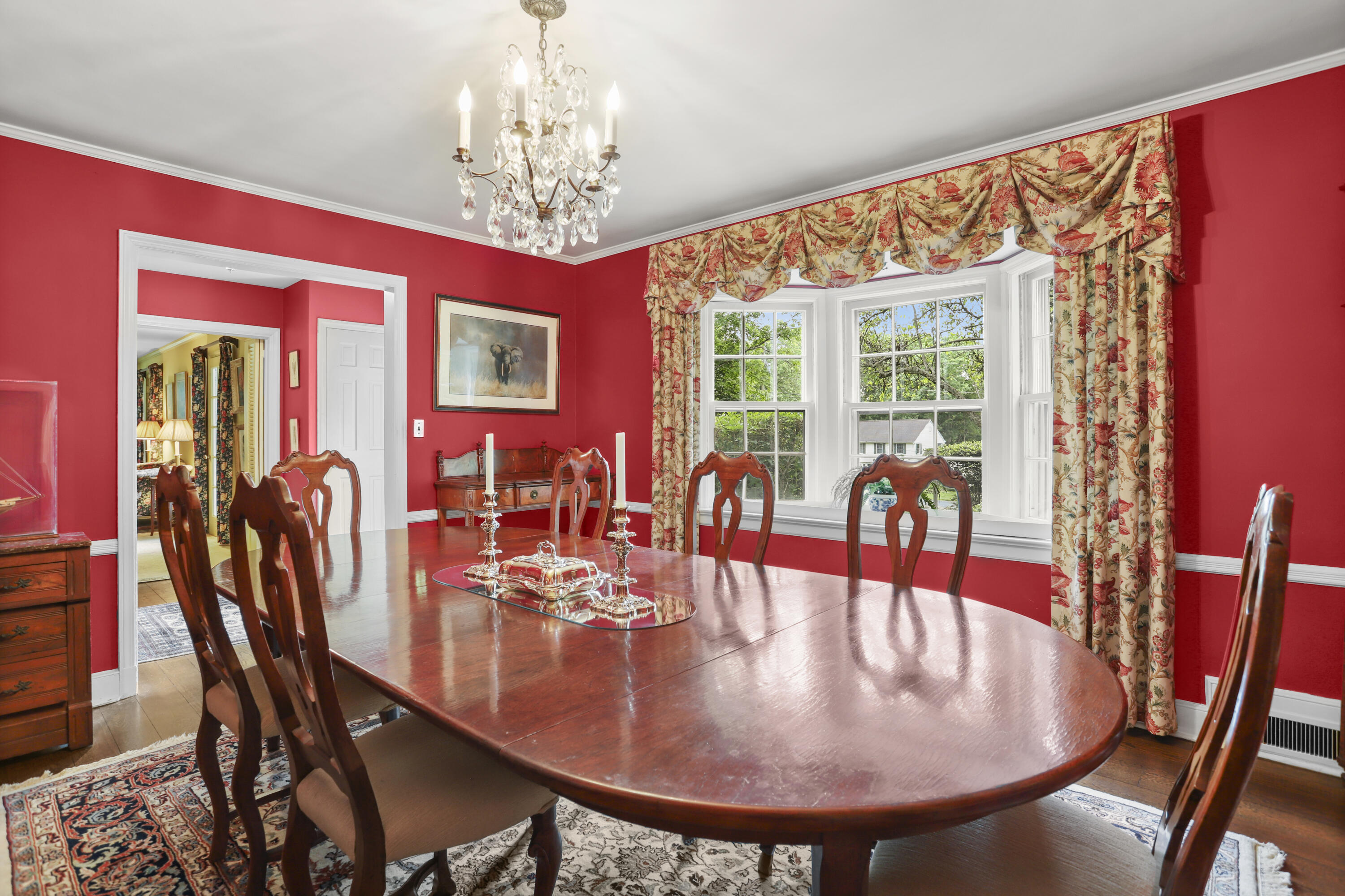 165 Colonial Road New Canaan, CT 06840 - Photo 12 of 37 a dining room with furniture a rug and a chandelier