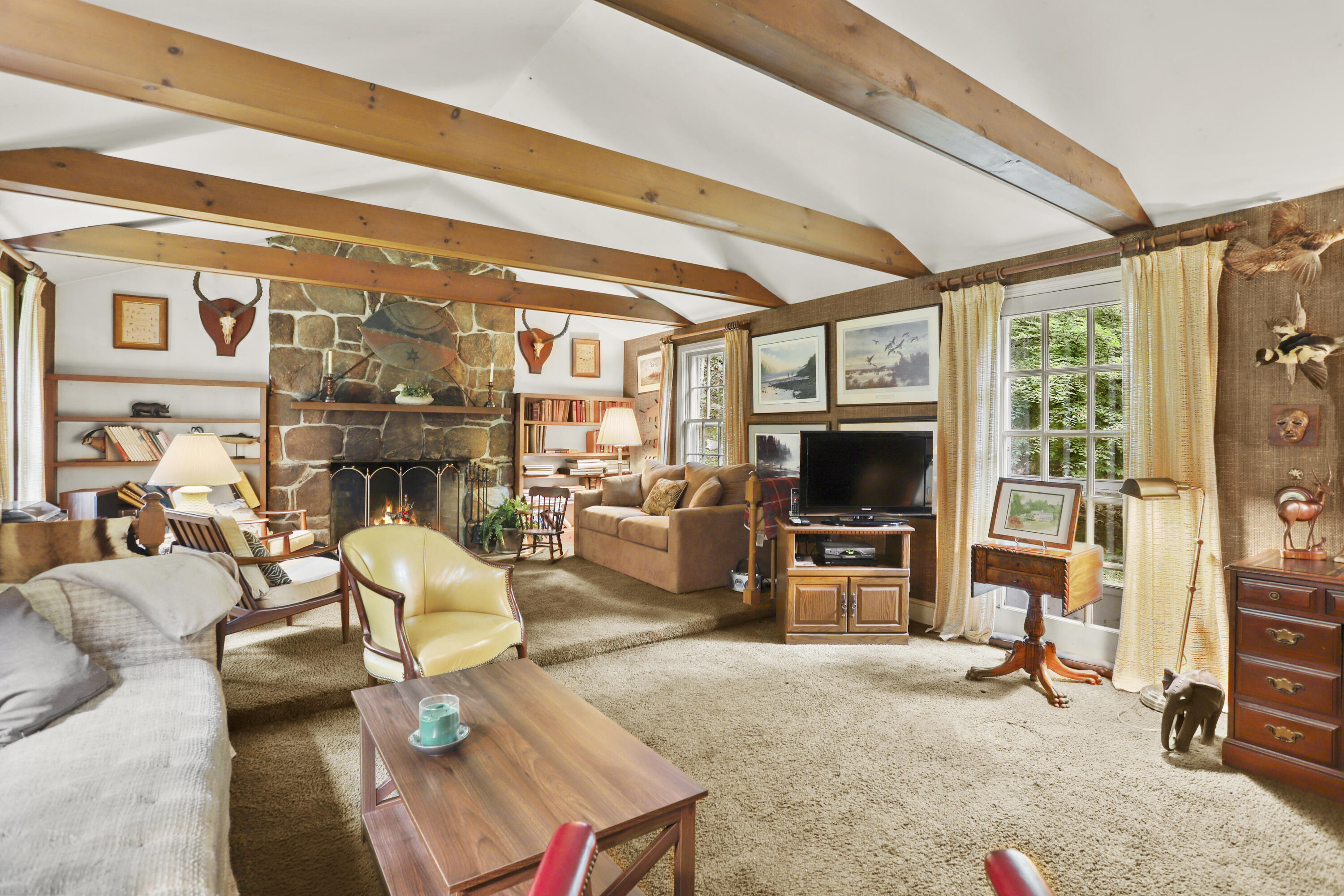 165 Colonial Road New Canaan, CT 06840 - Photo 15 of 37 a living room with furniture a flat screen tv and a fireplace