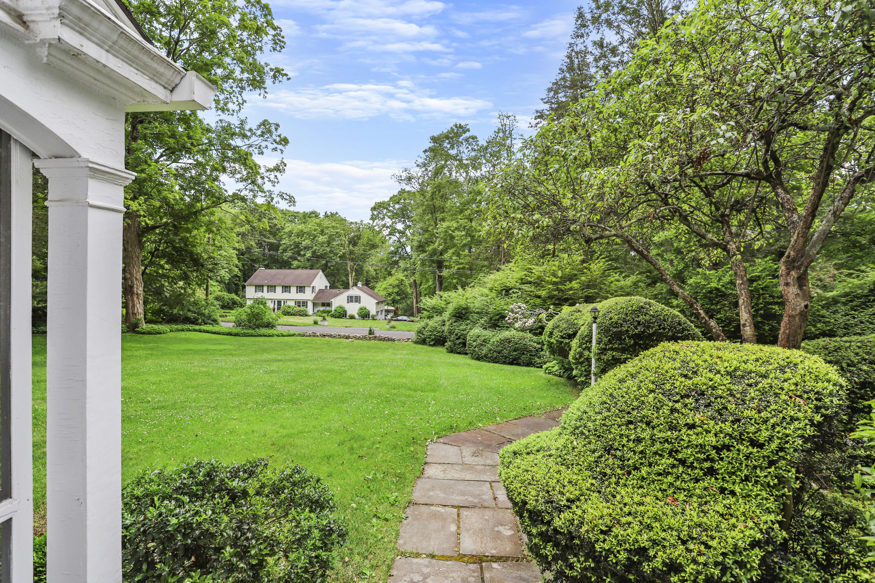 165 Colonial Road New Canaan, CT 06840 - Photo 31 of 37 a view of a garden with large trees