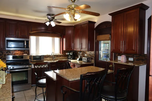a kitchen with a table chairs stove and microwave