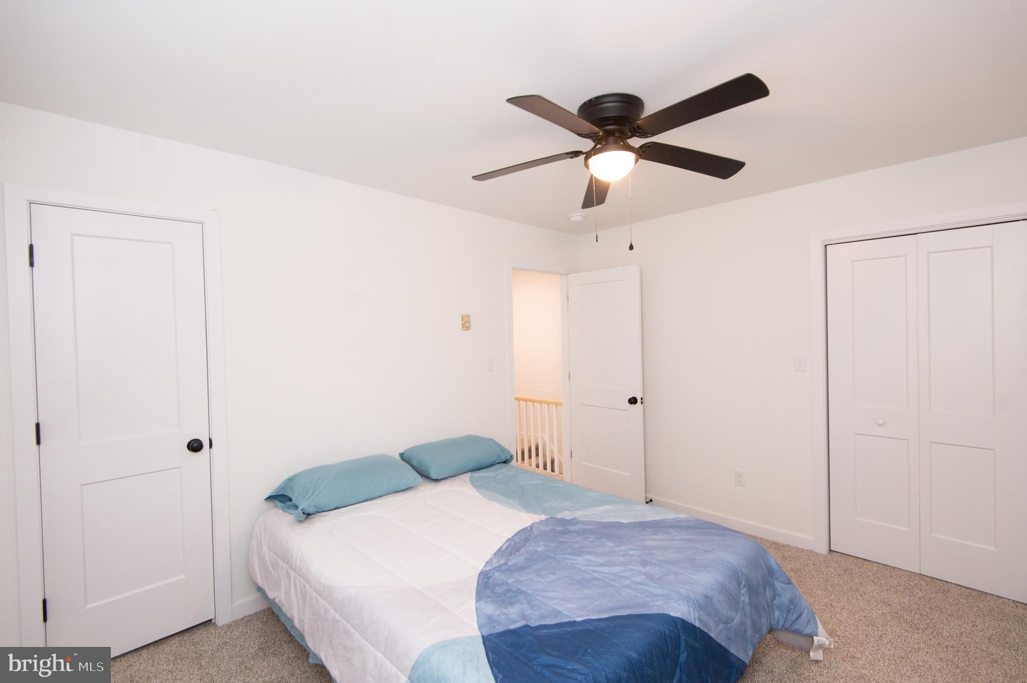904 Oakley Terrace Cambridge, MD 21613 - Photo 20 of 30 a bedroom with a bed and a ceiling fan