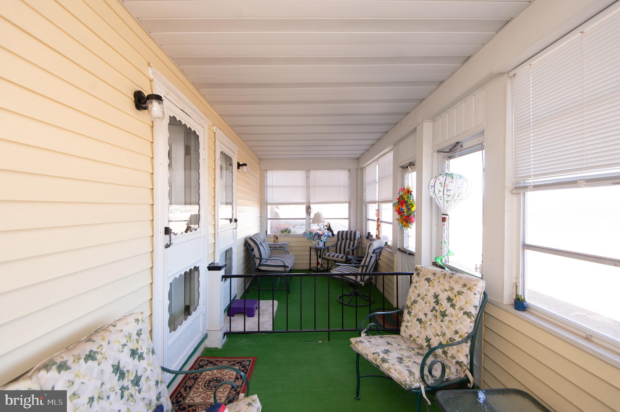 904 Oakley Terrace Cambridge, MD 21613 - Photo 22 of 30 a living room filled with furniture and a floor to ceiling window