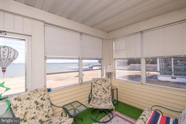 a bed room with furniture and floor to ceiling window