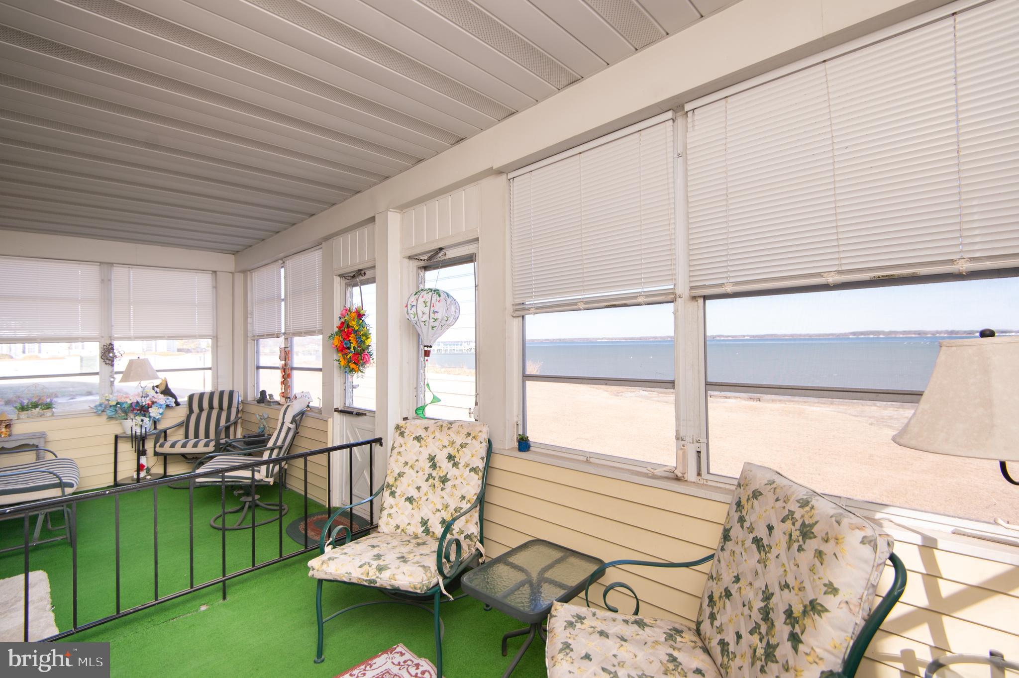 904 Oakley Terrace Cambridge, MD 21613 - Photo 24 of 30 a bed room with furniture and floor to ceiling window