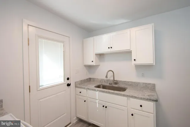 a kitchen with a sink and cabinets