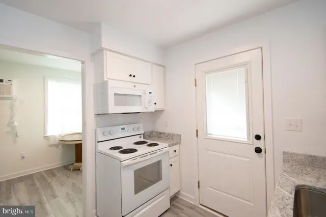 a kitchen with a stove and a refrigerator