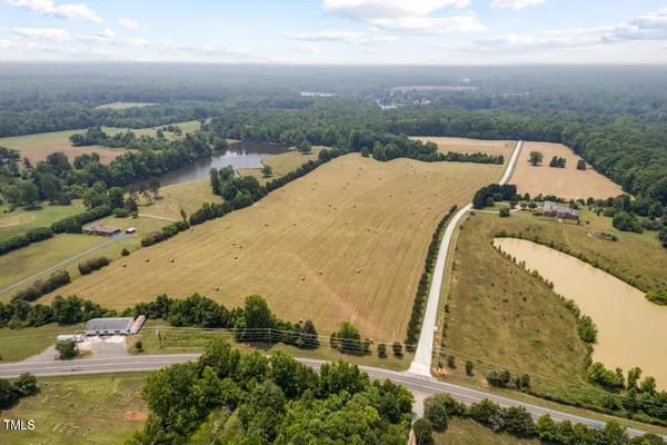 an aerial view of a house with a yard and lake view