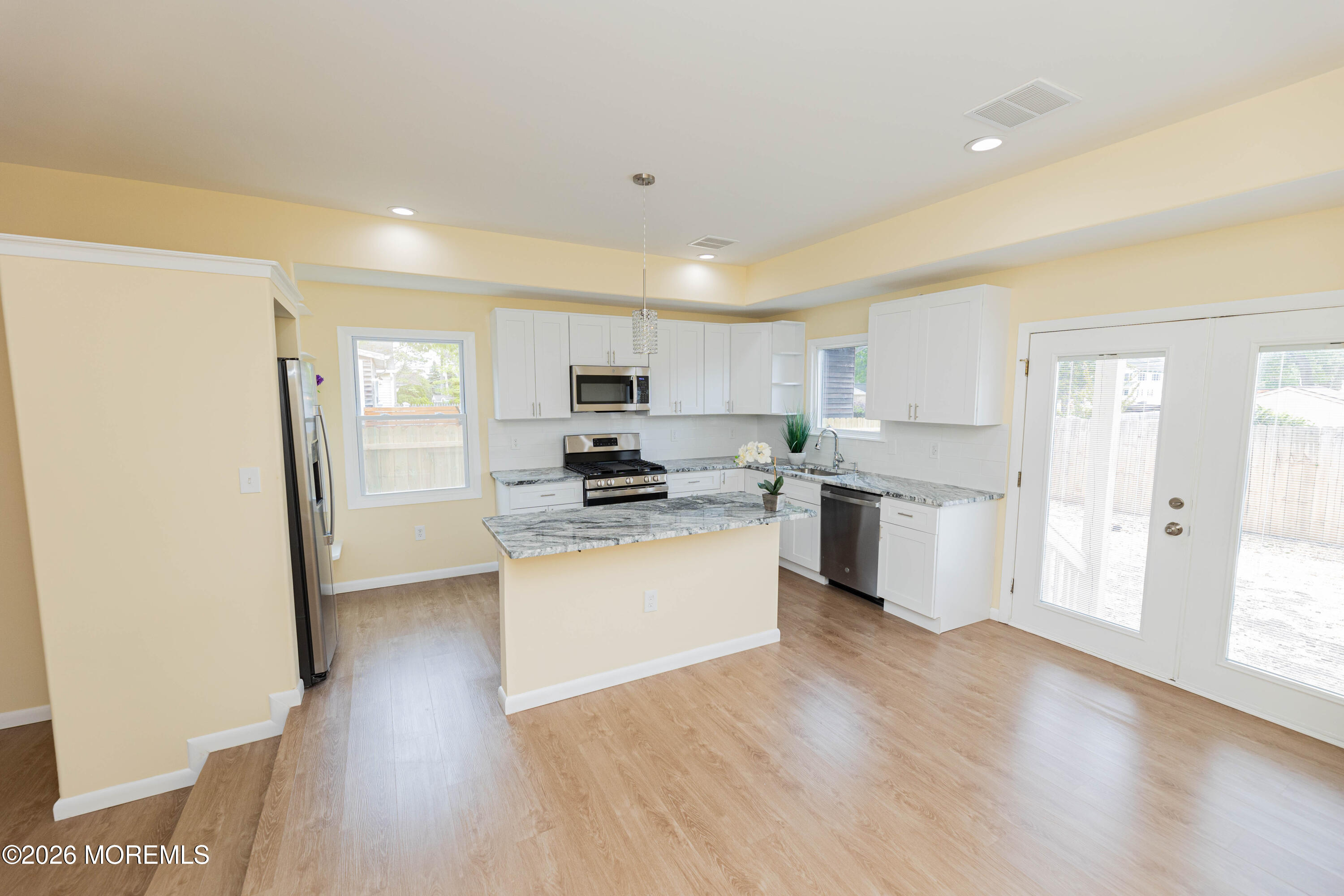 2408 Herbertsville Road Point Pleasant, NJ 08742 - Photo 14 of 82 a kitchen with white cabinets and stainless steel appliances