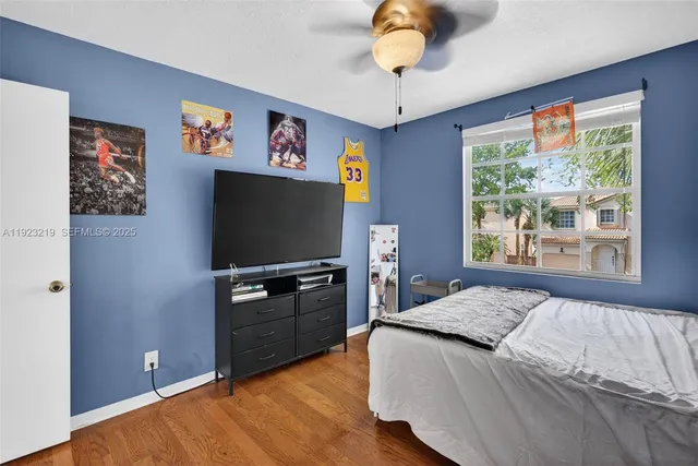 a bedroom with a bed and a flat screen tv