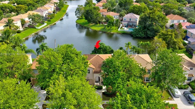 an aerial view of residential houses with outdoor space and trees