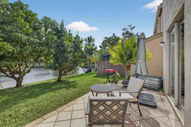a view of a patio with table and chairs and potted plants