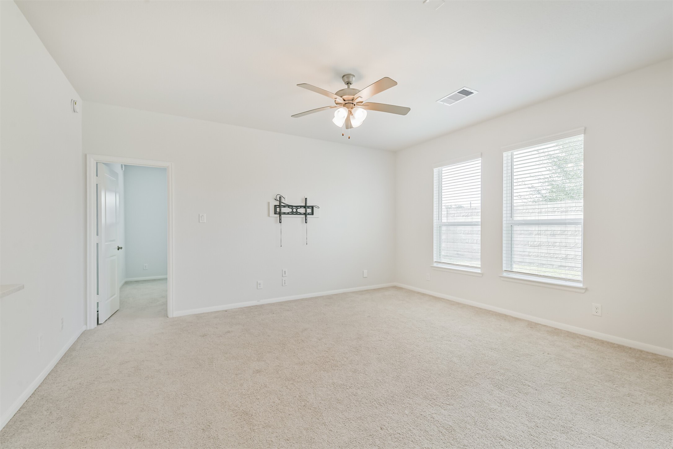 2129 Solstice Boulevard Spring, TX 77386 - Photo 22 of 49 Bright and spacious room with large windows for natural light. Neutral paint and carpet make it easy to personalize. Ideal as a home office, guest room, or optional fourth bedroom. Convenient access to an adjacent closet and hallway.