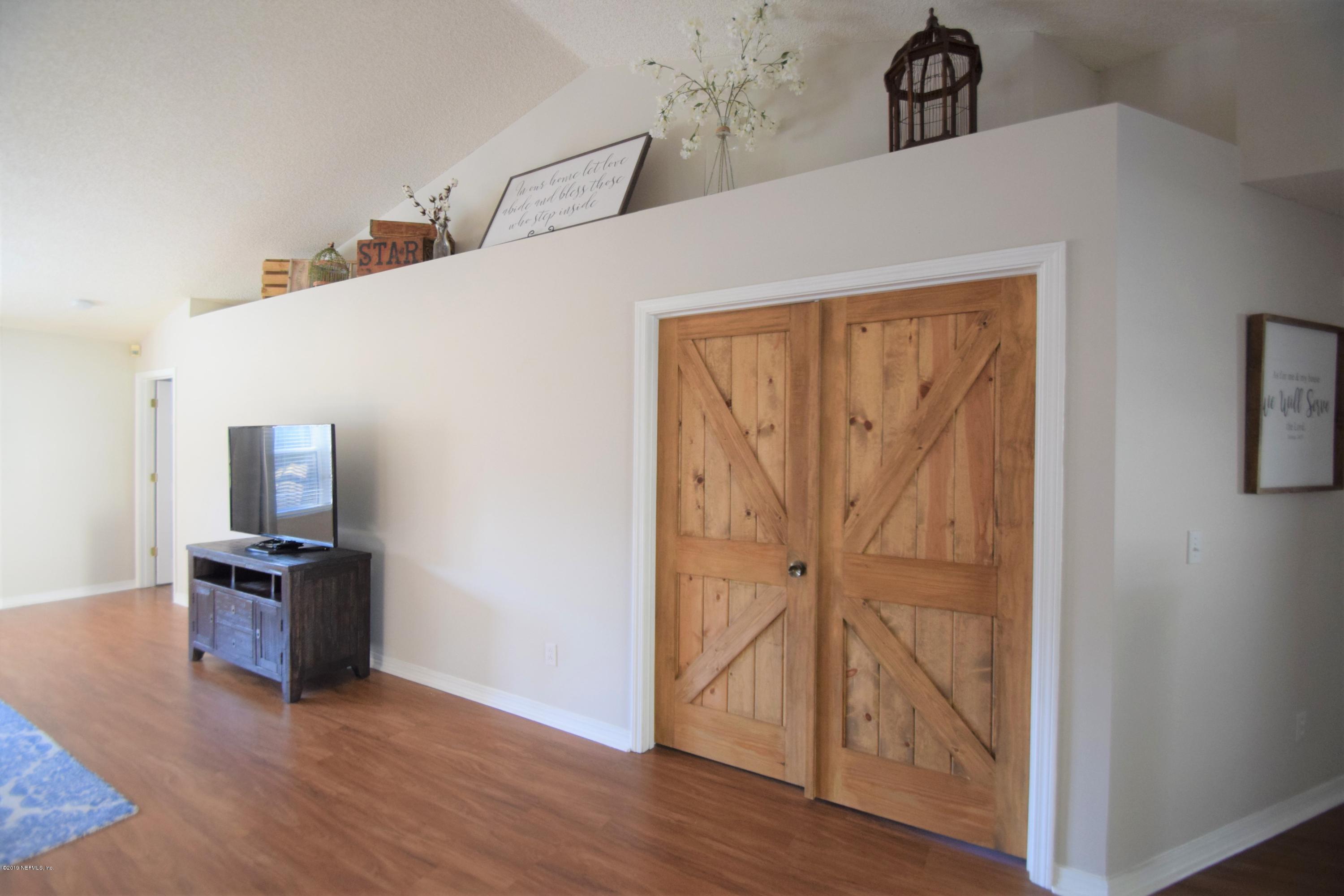 805 Sugarcane Avenue St. Augustine, FL 32095 - Photo 12 of 20 a view of a hallway with wooden floor and cabinet