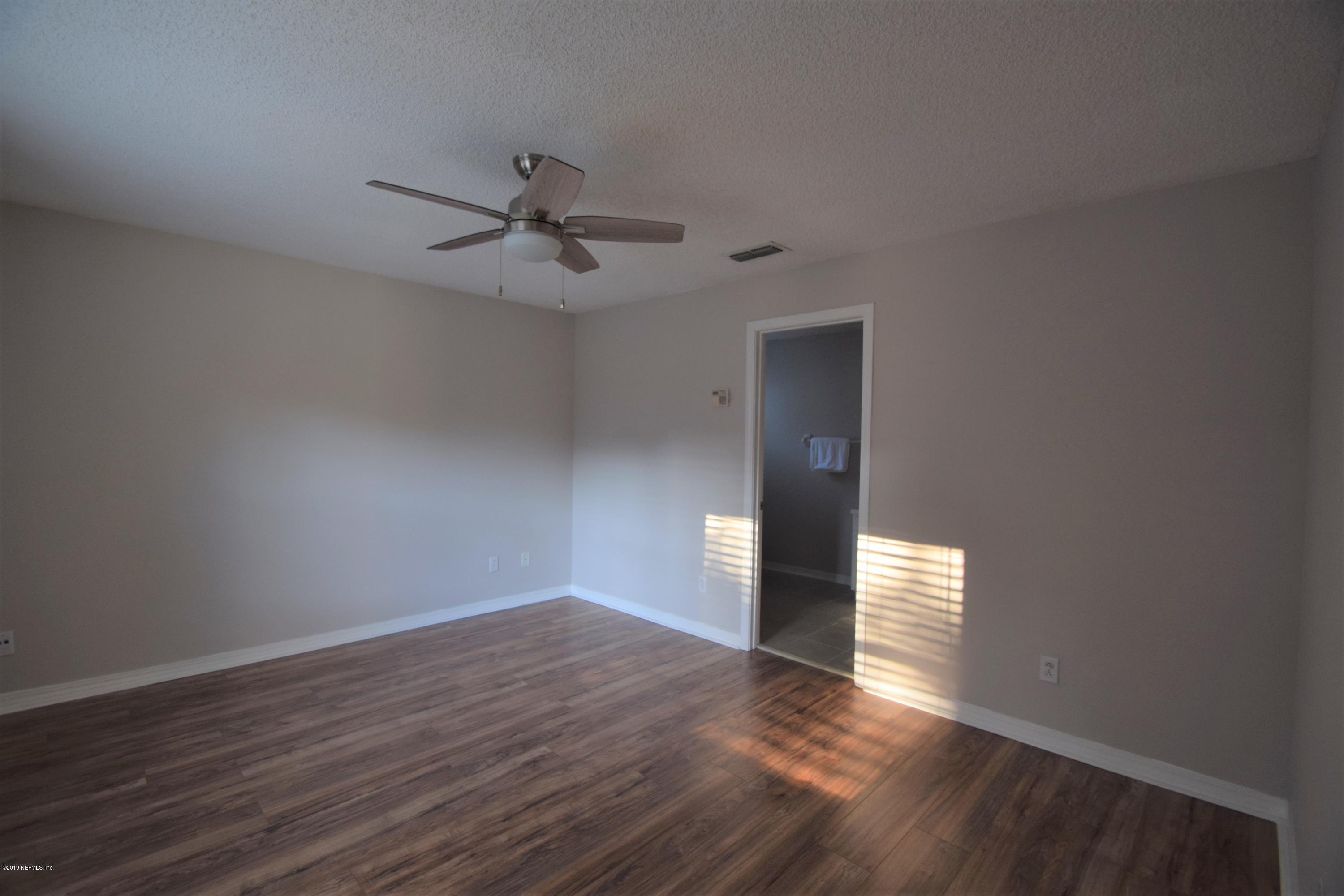 805 Sugarcane Avenue St. Augustine, FL 32095 - Photo 13 of 20 a view of empty room with wooden floor and ceiling fan