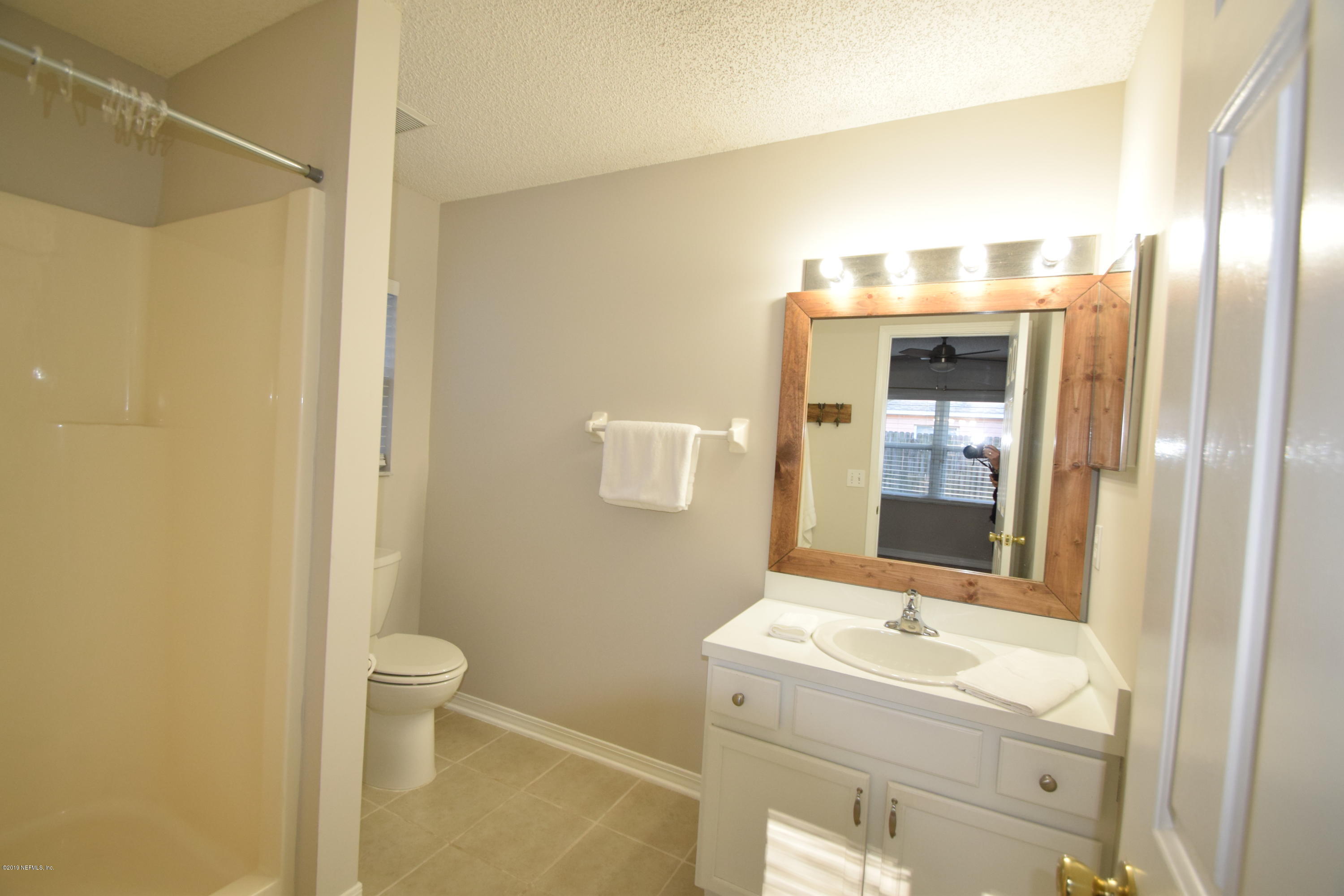 805 Sugarcane Avenue St. Augustine, FL 32095 - Photo 14 of 20 a bathroom with a granite countertop sink and a mirror