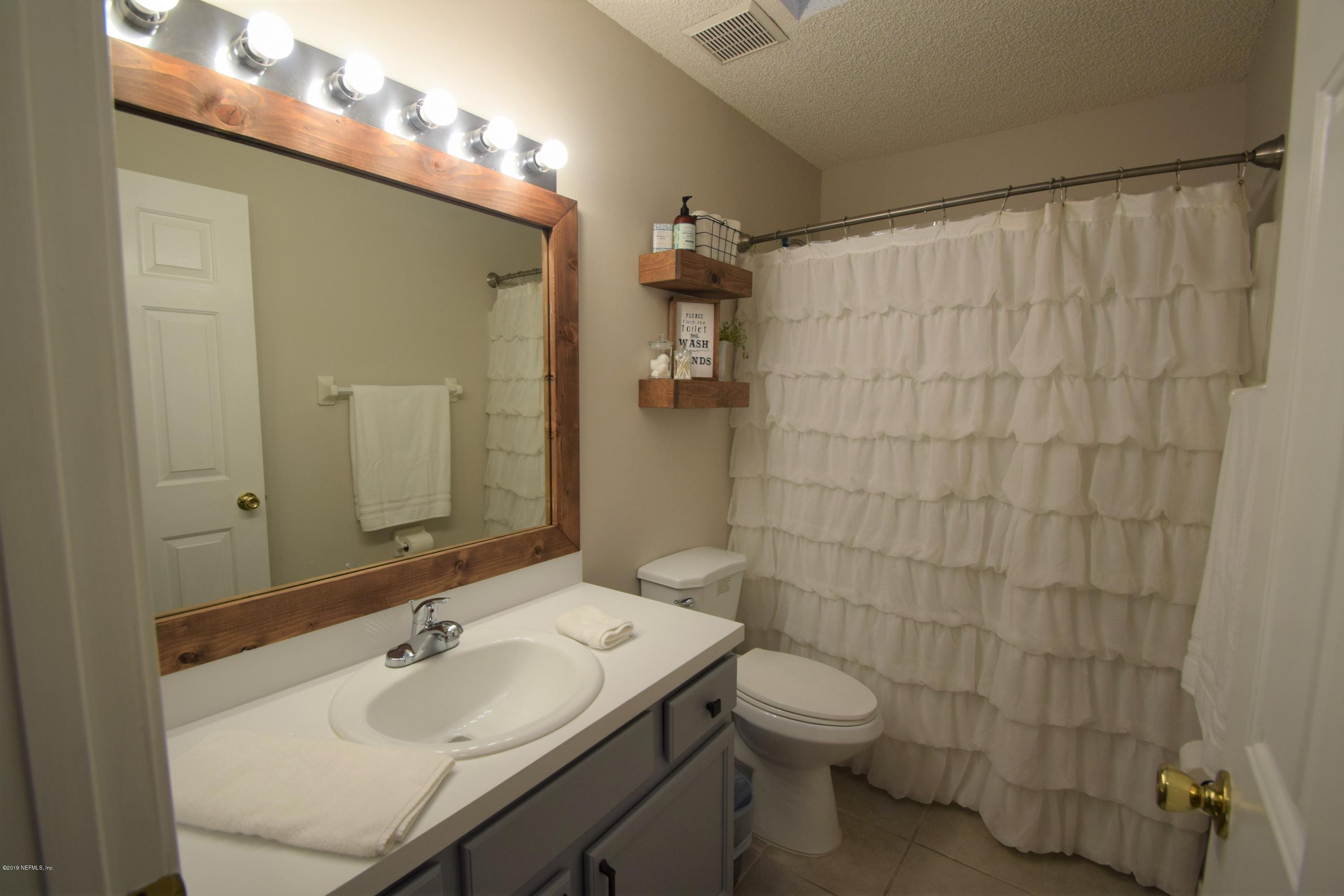 805 Sugarcane Avenue St. Augustine, FL 32095 - Photo 16 of 20 a bathroom with a sink a toilet and shower