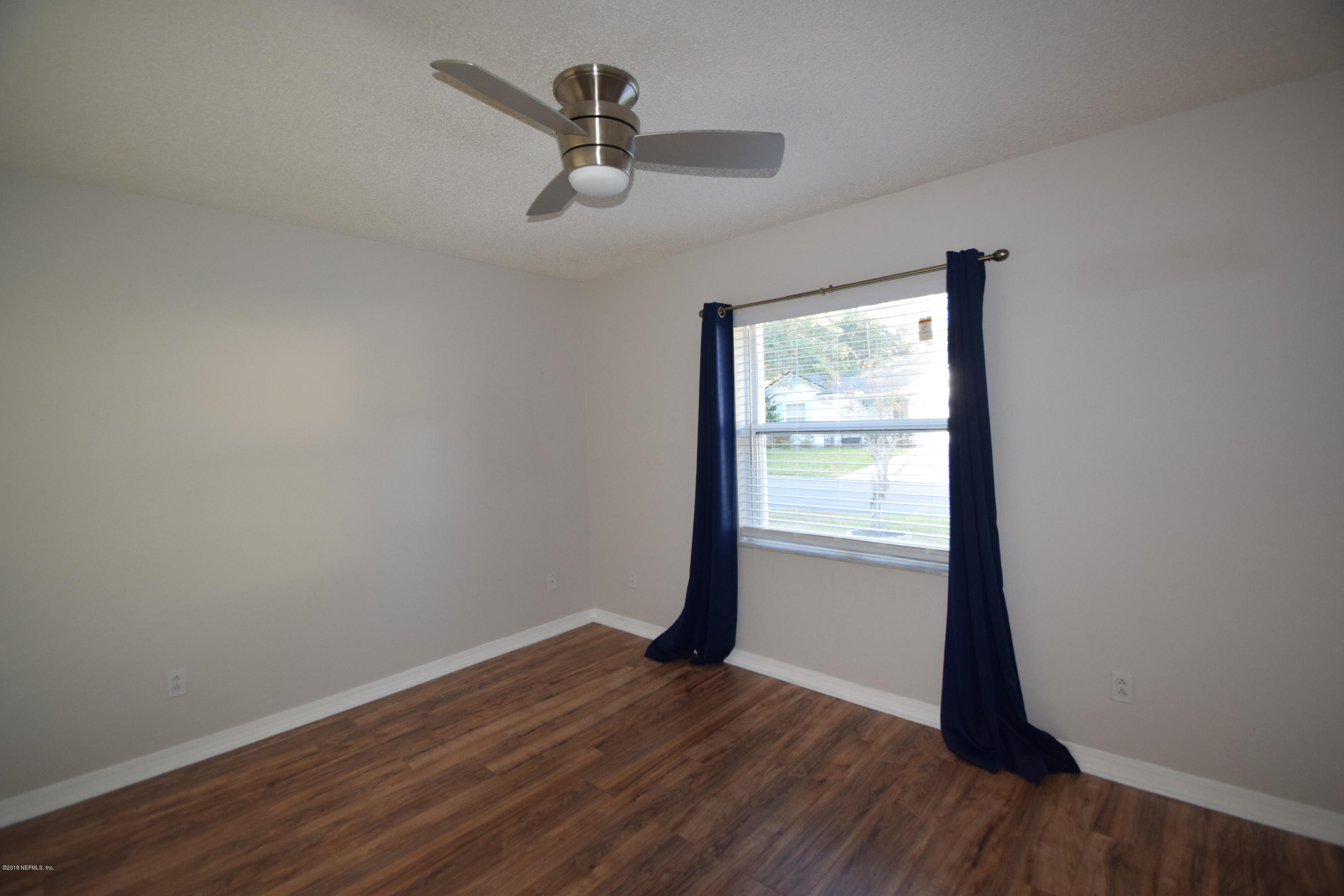 805 Sugarcane Avenue St. Augustine, FL 32095 - Photo 18 of 20 a view of empty room with wooden floor and fan