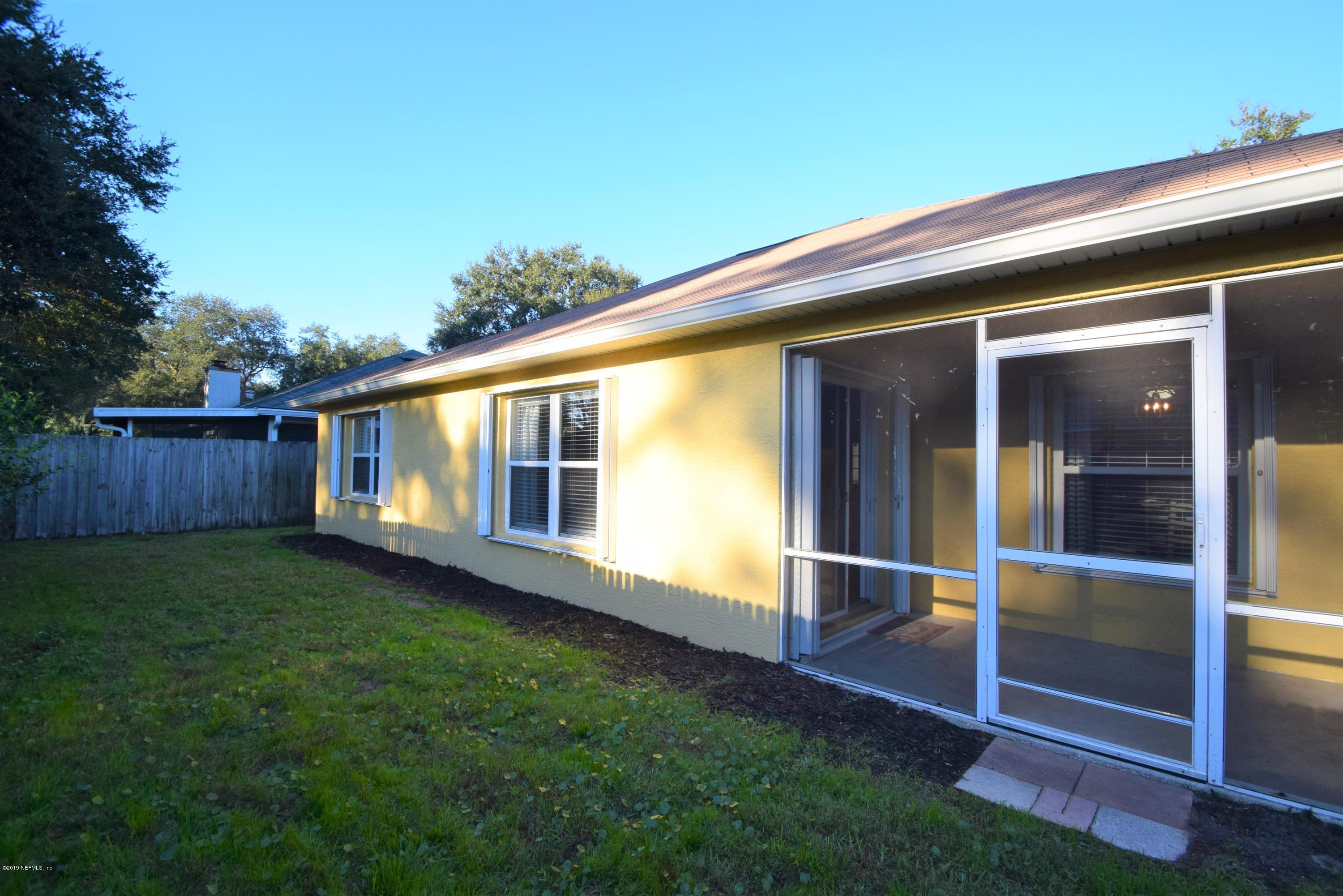 805 Sugarcane Avenue St. Augustine, FL 32095 - Photo 19 of 20 a backyard with wooden fence and a porch