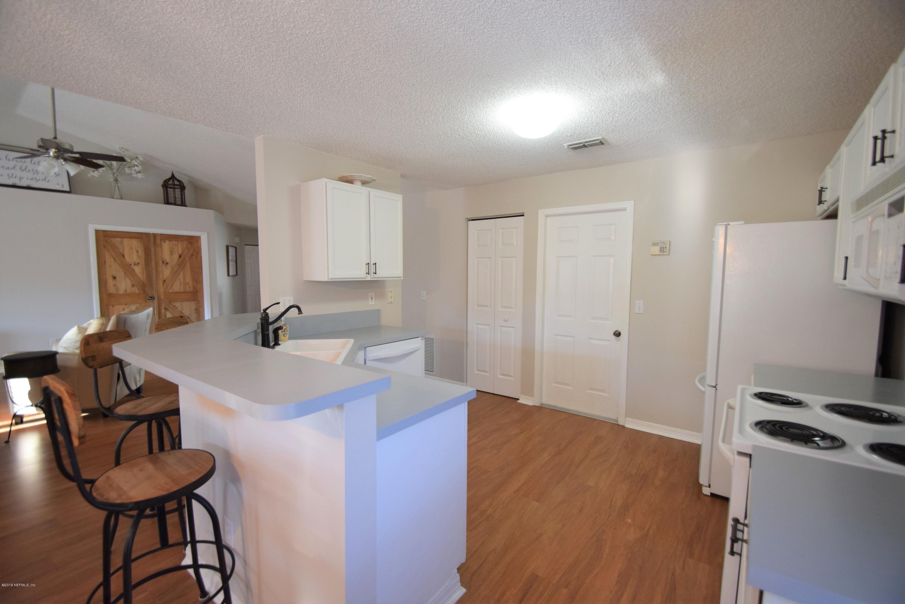 805 Sugarcane Avenue St. Augustine, FL 32095 - Photo 8 of 20 a room with a sink a desk and chairs