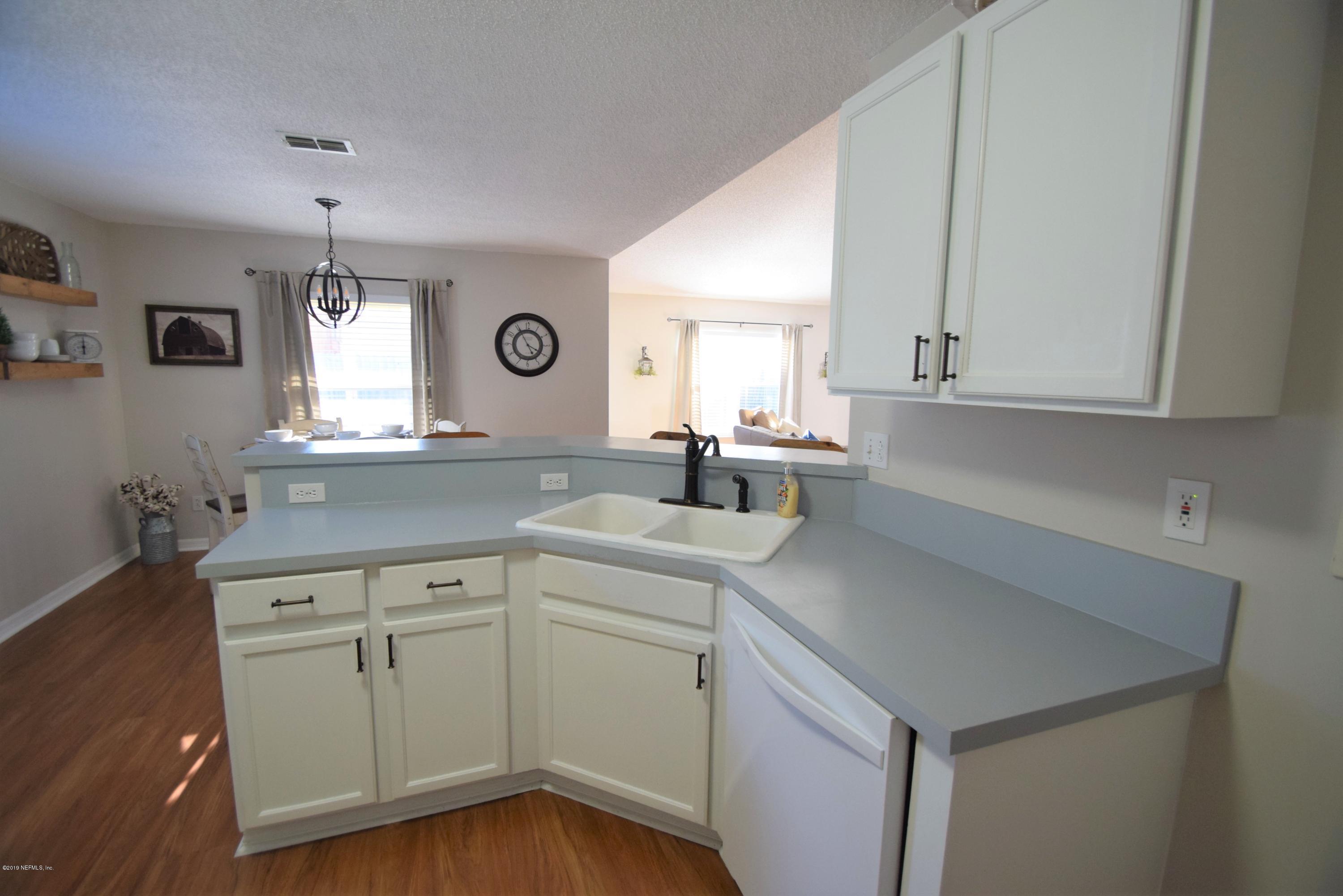 805 Sugarcane Avenue St. Augustine, FL 32095 - Photo 9 of 20 a kitchen with a sink cabinets and window