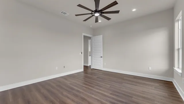 a spacious bathroom with a tub sink and mirror