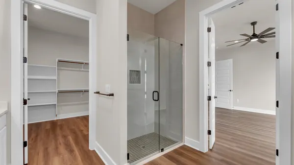 a bathroom with a double vanity sink a mirror and shower