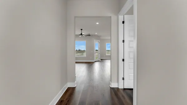 a view of a hallway with wooden floor