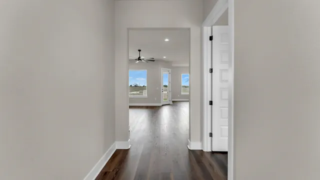 a view of a hallway with wooden floor