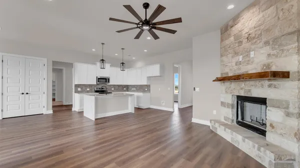 a view of kitchen with microwave and cabinets