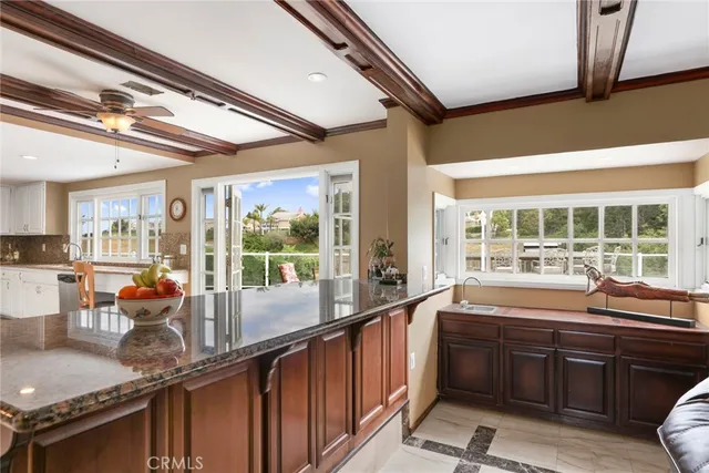 a kitchen with large windows and a sink