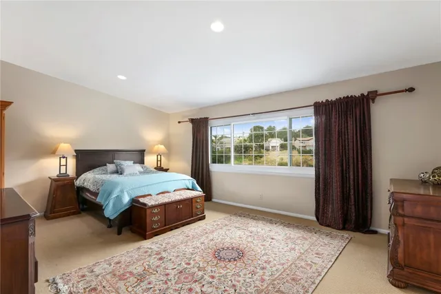 a bedroom with a large bed and a window