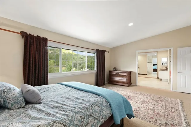 a bedroom with a large bed and a large window