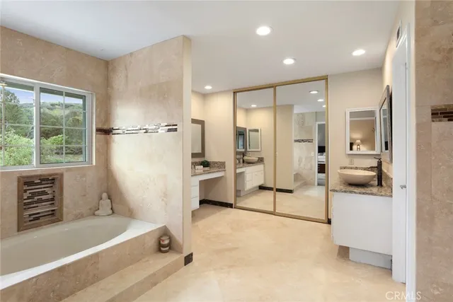 a bathroom with a tub sink and shower