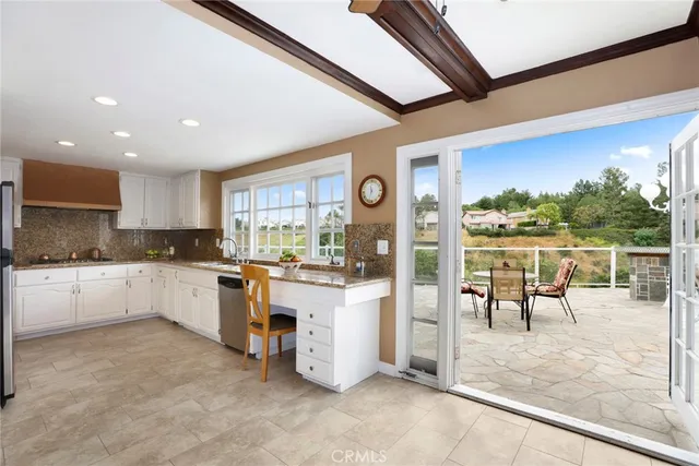 a kitchen with a sink and chairs
