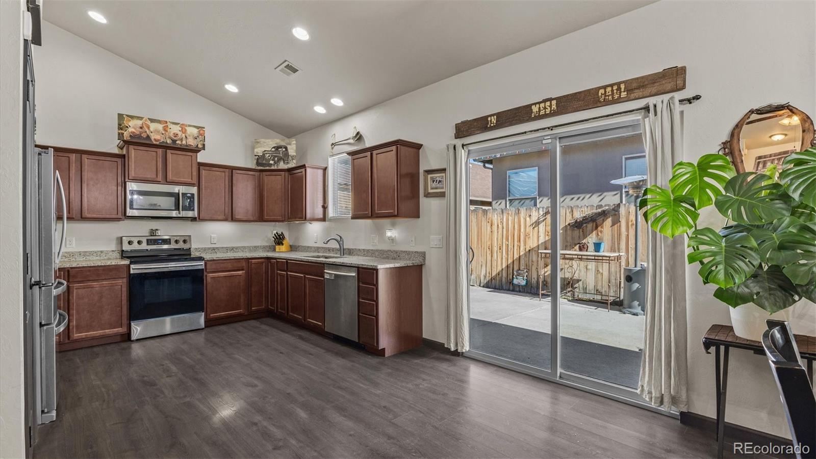 556-32 32 5/8 Road Clifton, CO 81520 - Photo 12 of 28 a kitchen with a refrigerator and a stove top oven